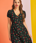 Woman wearing vintage-inspired cherry print midi dress with V-neckline