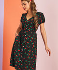 Side angle of cute vintage-inspired black cherry print midi dress with waist tie