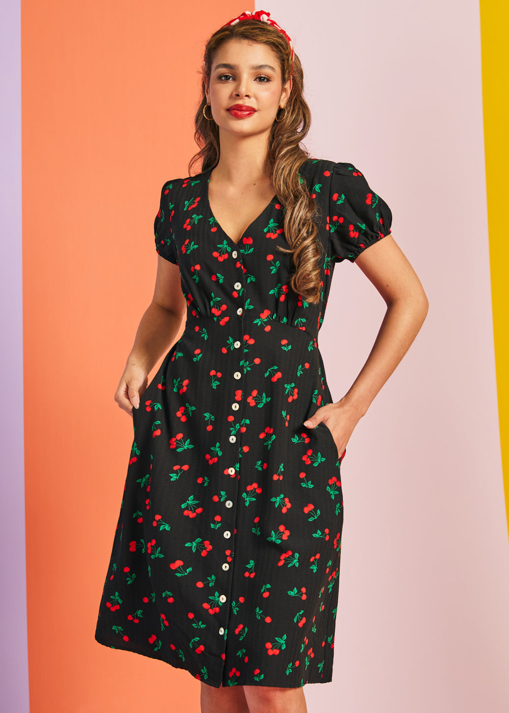 Front view of black cherry print casual dress with button-front closure and pockets
