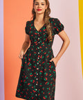 Front view of black cherry print casual dress with button-front closure and pockets