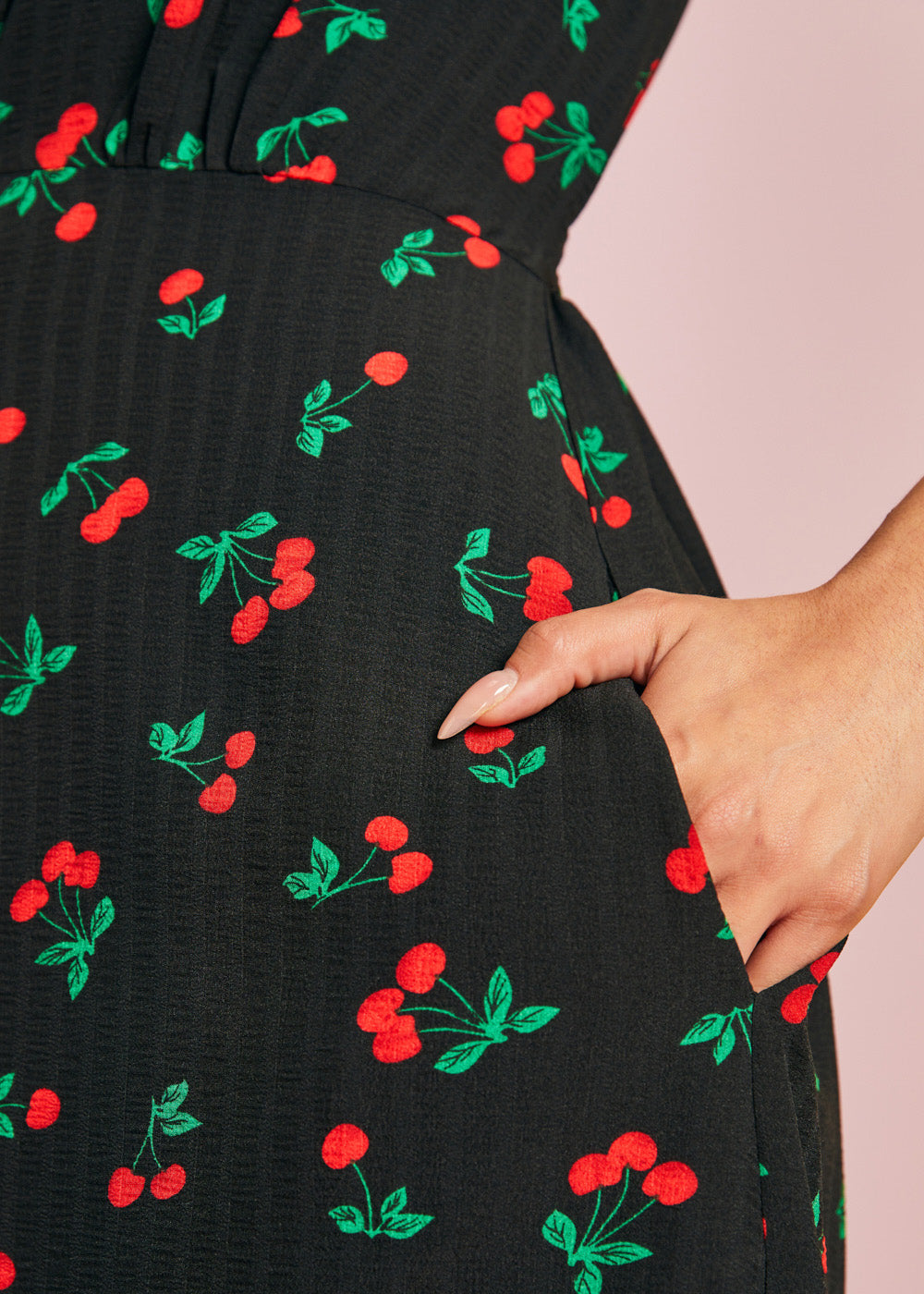 Close-up of side pocket on black cherry print midi dress