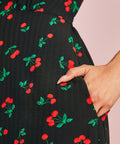Close-up of side pocket on black cherry print midi dress
