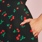 Close-up of side pocket on black cherry print midi dress