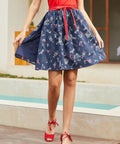 Navy blue wrap skirt with mermaid and nautical novelty print front view
