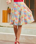 Model wearing colorful umbrella print circle skirt with red sleeveless top, front view