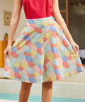 Woman wearing a colorful patterned skirt and red top