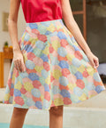 Woman wearing a colorful patterned skirt with a blurred background