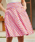 Woman wearing a colorful striped skirt with pockets