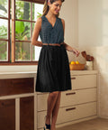 Woman wearing black retro skirt styled with sleeveless polka dot top and spectator heels