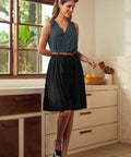 Woman styling a vintage-inspired polka dot sleeveless top with a skirt