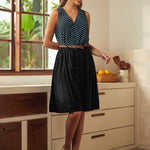 Woman styling a vintage-inspired polka dot sleeveless top with a skirt