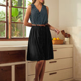 Woman styling a vintage-inspired polka dot sleeveless top with a skirt