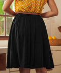 Back view of black vintage-inspired gathered skirt with braided belt