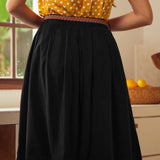 Back view of black vintage-inspired gathered skirt with braided belt