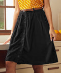 Black gathered midi skirt styled in retro-inspired kitchen setting