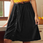 Black gathered midi skirt styled in retro-inspired kitchen setting