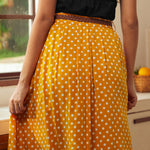 Back view of yellow polka dot gathered skirt with braided belt detail
