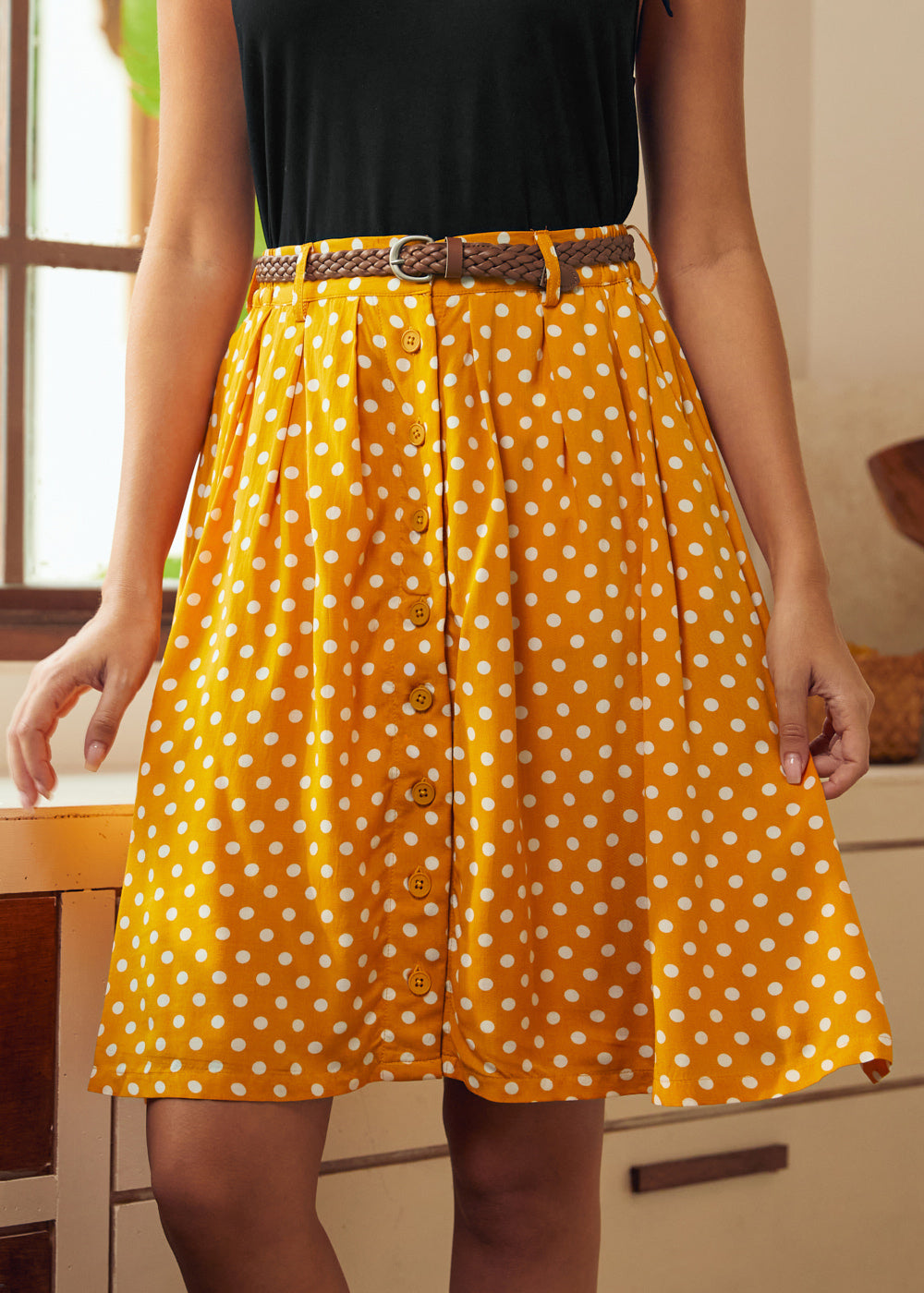 Front view of yellow polka dot midi skirt with vintage-inspired silhouette
