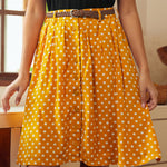 Front view of yellow polka dot midi skirt with vintage-inspired silhouette