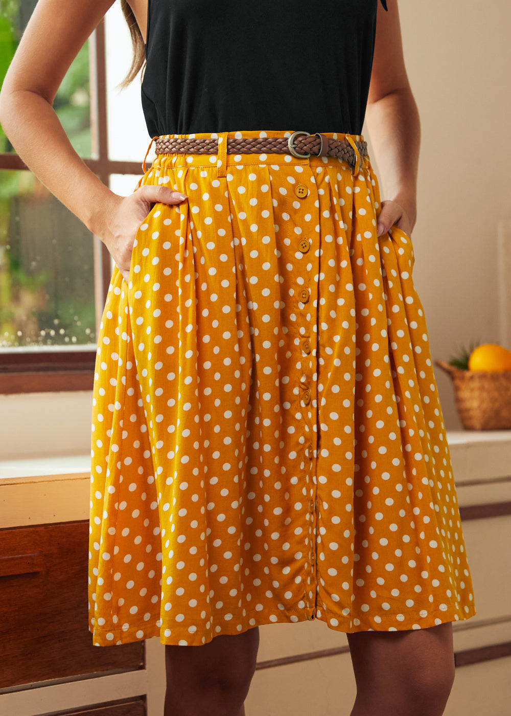 Front detail of yellow polka dot button-front skirt with gathered silhouette