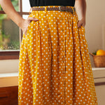 Front detail of yellow polka dot button-front skirt with gathered silhouette