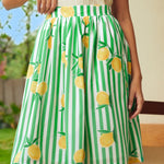 Close-up of gathered waist skirt with lemon print and stripe pattern