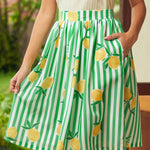 Green and white striped skirt with lemon pattern worn by a woman standing outdoors.