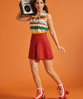 Woman styling a retro-inspired striped button-front blouse with a red mini skirt and roller skates.