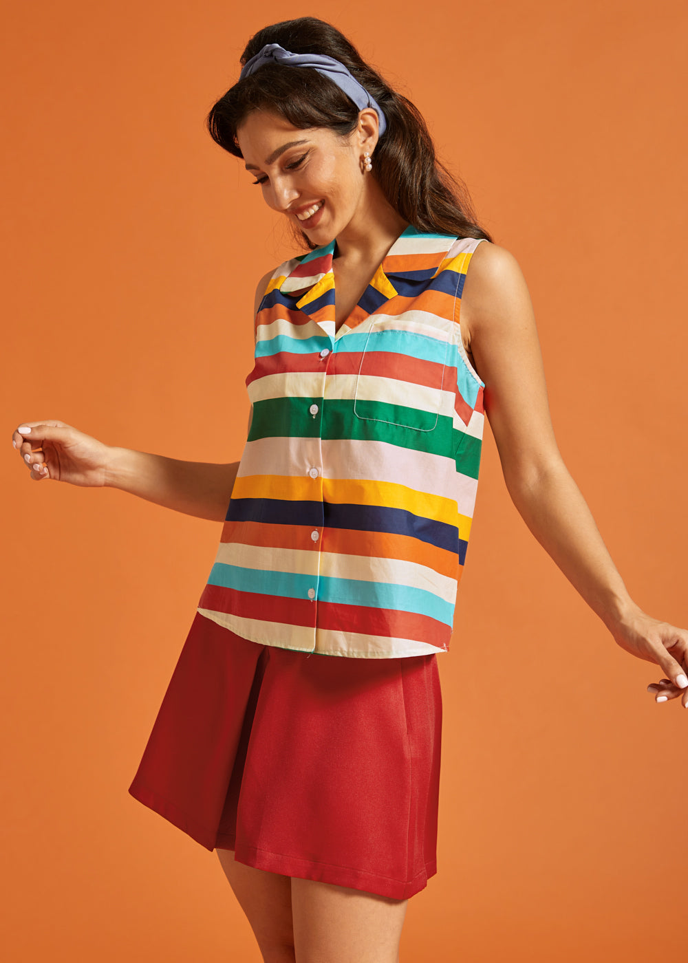 Side view of the rainbow striped cotton blouse with button-front closure.