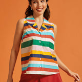 Woman wearing a retro rainbow striped sleeveless button-front top with a chest pocket.