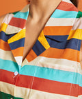 Close-up of the camp collar and colorful horizontal stripe pattern on the sleeveless blouse.