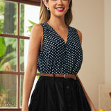 Woman wearing a black sleeveless blouse with white polka dots