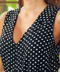 Close-up of polka dot blouse featuring a V-neckline and notch collar