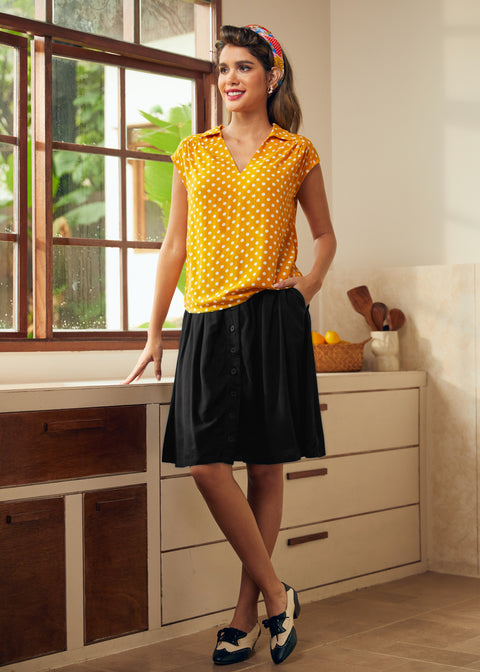Woman styling vintage-inspired polka dot blouse with retro flats