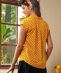 Back view of yellow polka dot cap sleeve blouse