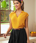 Woman wearing retro-inspired yellow dotted blouse with braided belt