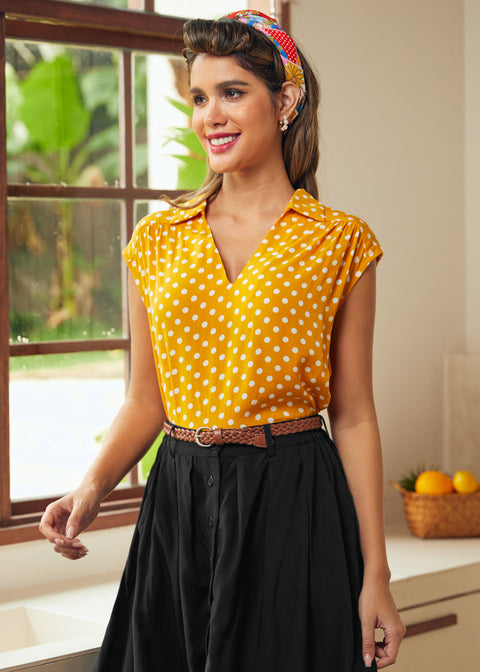 Woman wearing retro-inspired yellow dotted blouse with braided belt