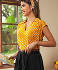Side view of mustard yellow polka dot blouse with relaxed fit