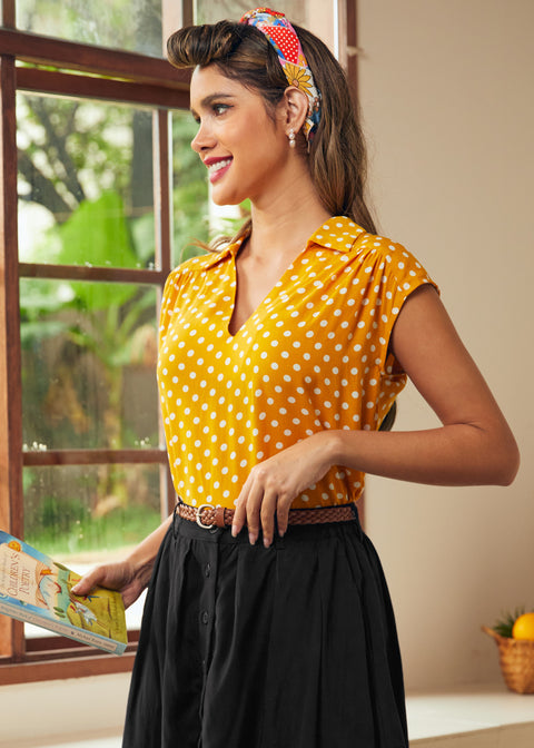 Side view of mustard yellow polka dot blouse with relaxed fit