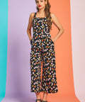 Front view of black fruit print wide-leg jumpsuit with square neckline