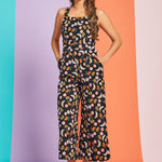 Front view of black fruit print wide-leg jumpsuit with square neckline
