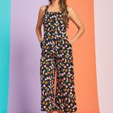 Front view of black fruit print wide-leg jumpsuit with square neckline