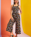 Woman wearing black fruit print cropped wide-leg jumpsuit with pockets