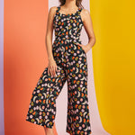 Woman wearing black fruit print cropped wide-leg jumpsuit with pockets