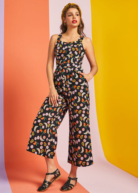 Woman wearing black fruit print cropped wide-leg jumpsuit with pockets