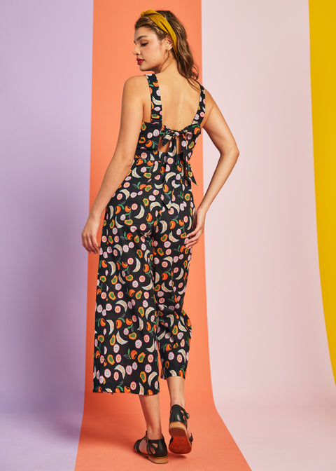 Back view of cropped wide-leg fruit print jumpsuit with bow tie detail