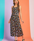 Woman wearing retro-inspired fruit print jumpsuit with cropped legs