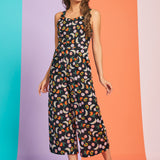Woman wearing retro-inspired fruit print jumpsuit with cropped legs