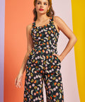 Woman wearing retro black fruit print jumpsuit with pockets