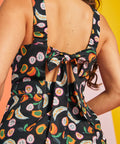 Tie-back detail on black novelty fruit print jumpsuit